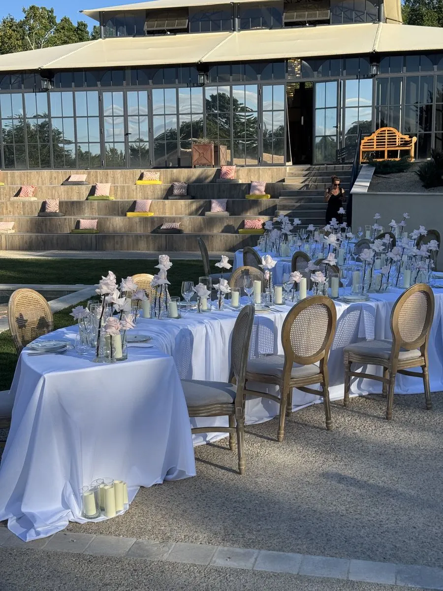 Tables dressées de roses blanches au bord de la piscine